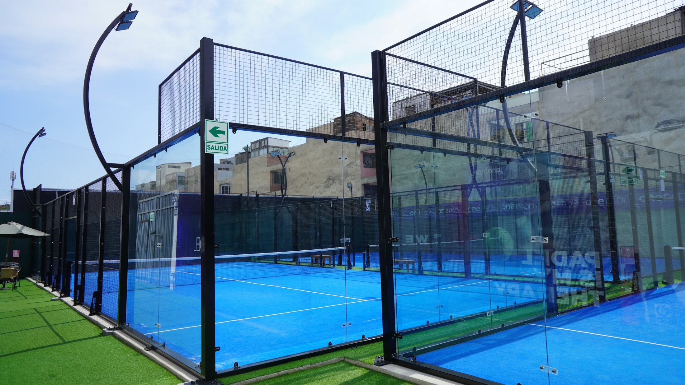 Outdoor glass-walled padel courts